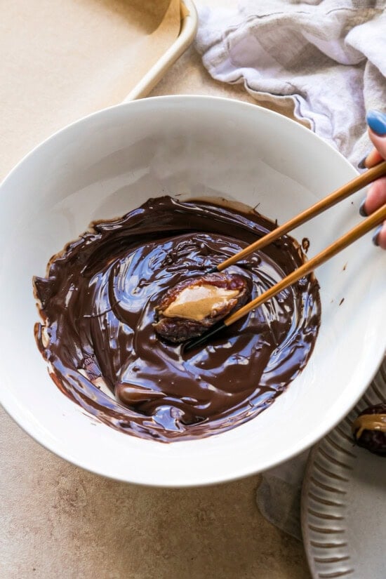 using chopsticks, dip into chocolate leaving PB exposed.