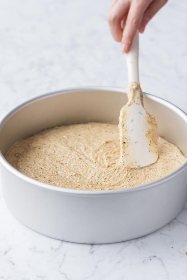 Smoothing out the top of the batter with a wide rubber spatula.