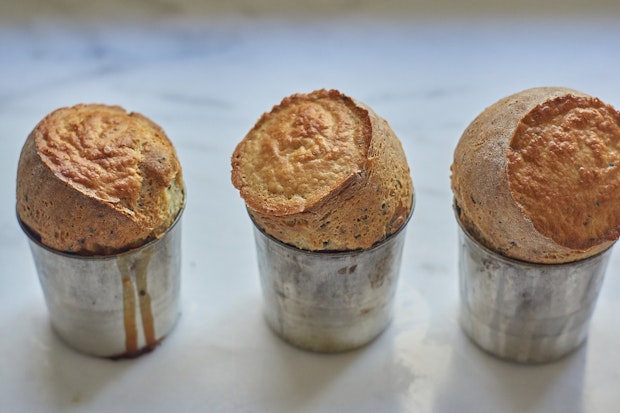 freshly baked seeded popovers just out of the oven on a counter