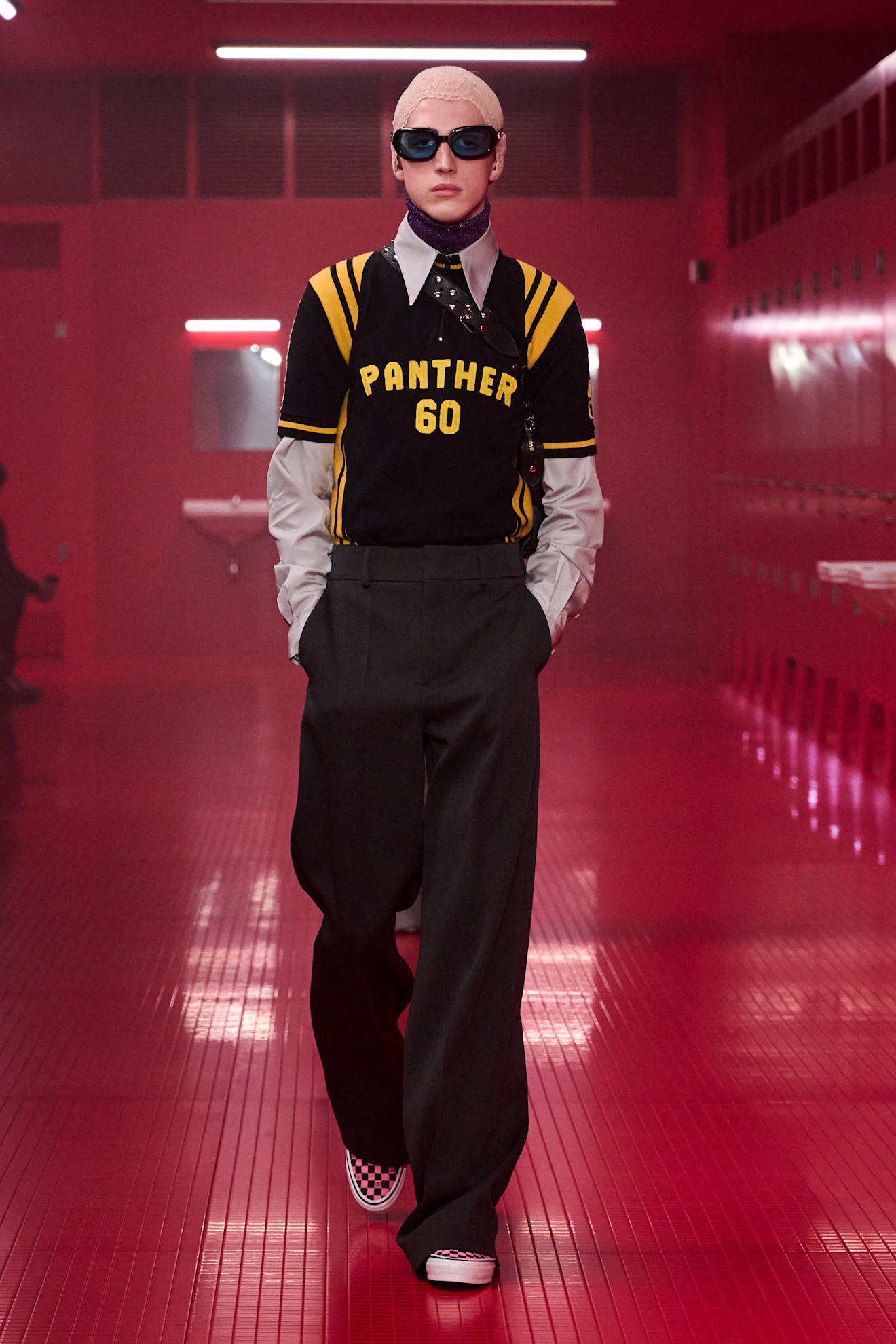 A model in the F/W 25 Valentino show wearing Vans Valentino collaboration checkerboard sneakers.