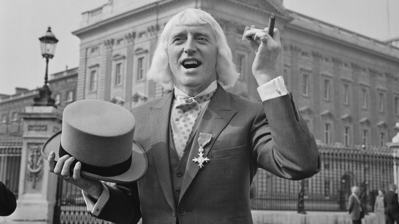 Jimmy Savile outside Buckingham Palace