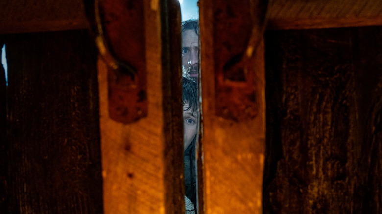 Spike and  Jamie looking through a door