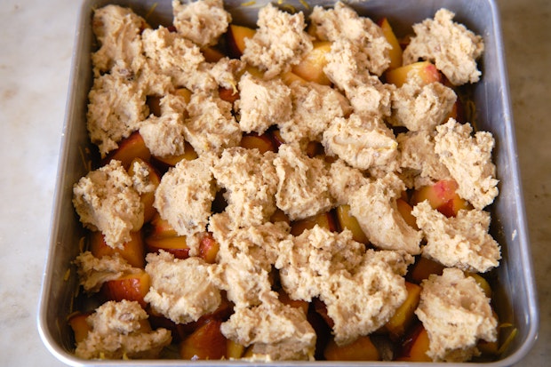 peach cobbler in a pan before baking