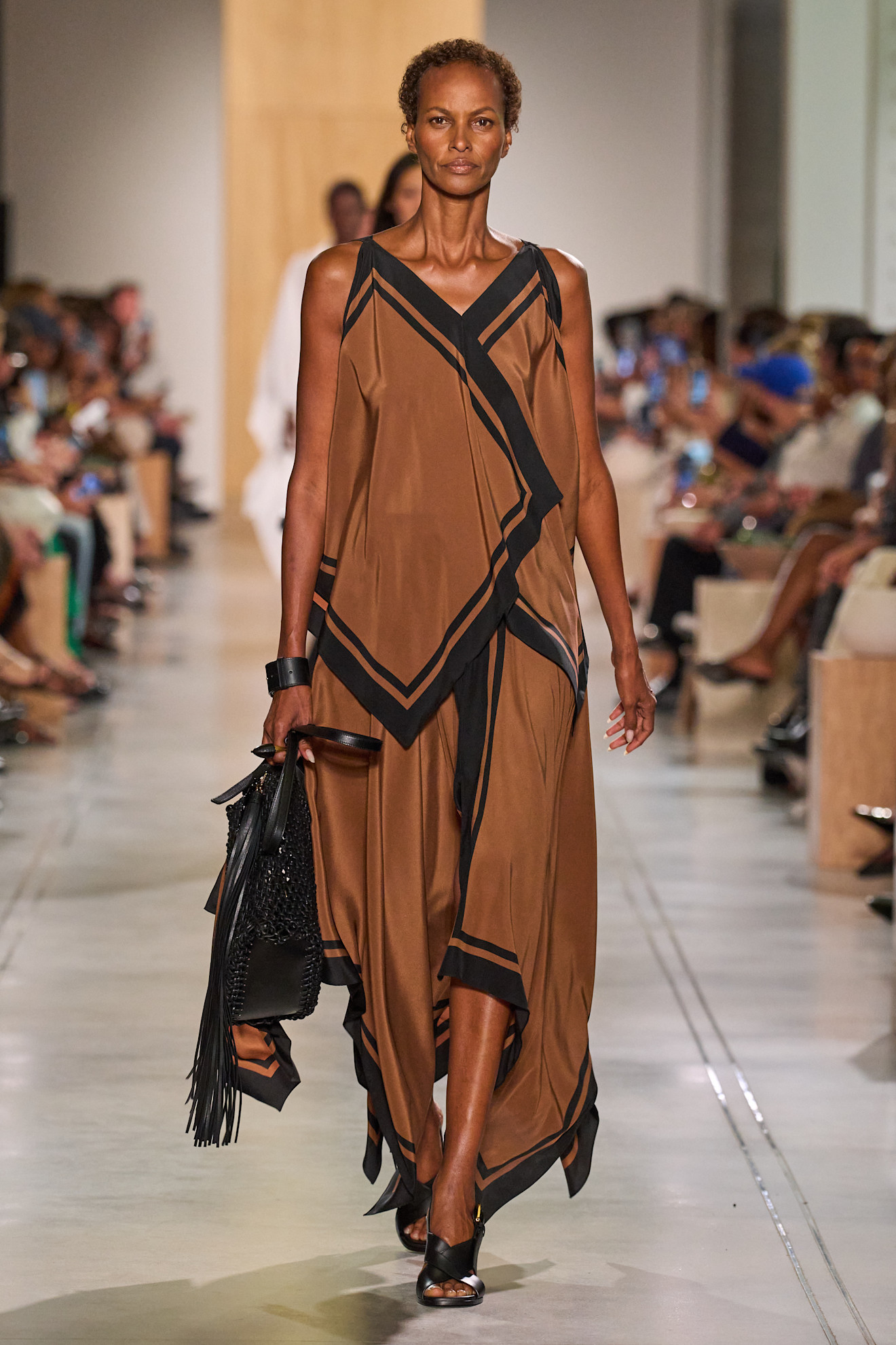 A Michael Kors model wearing a silk brown and black set