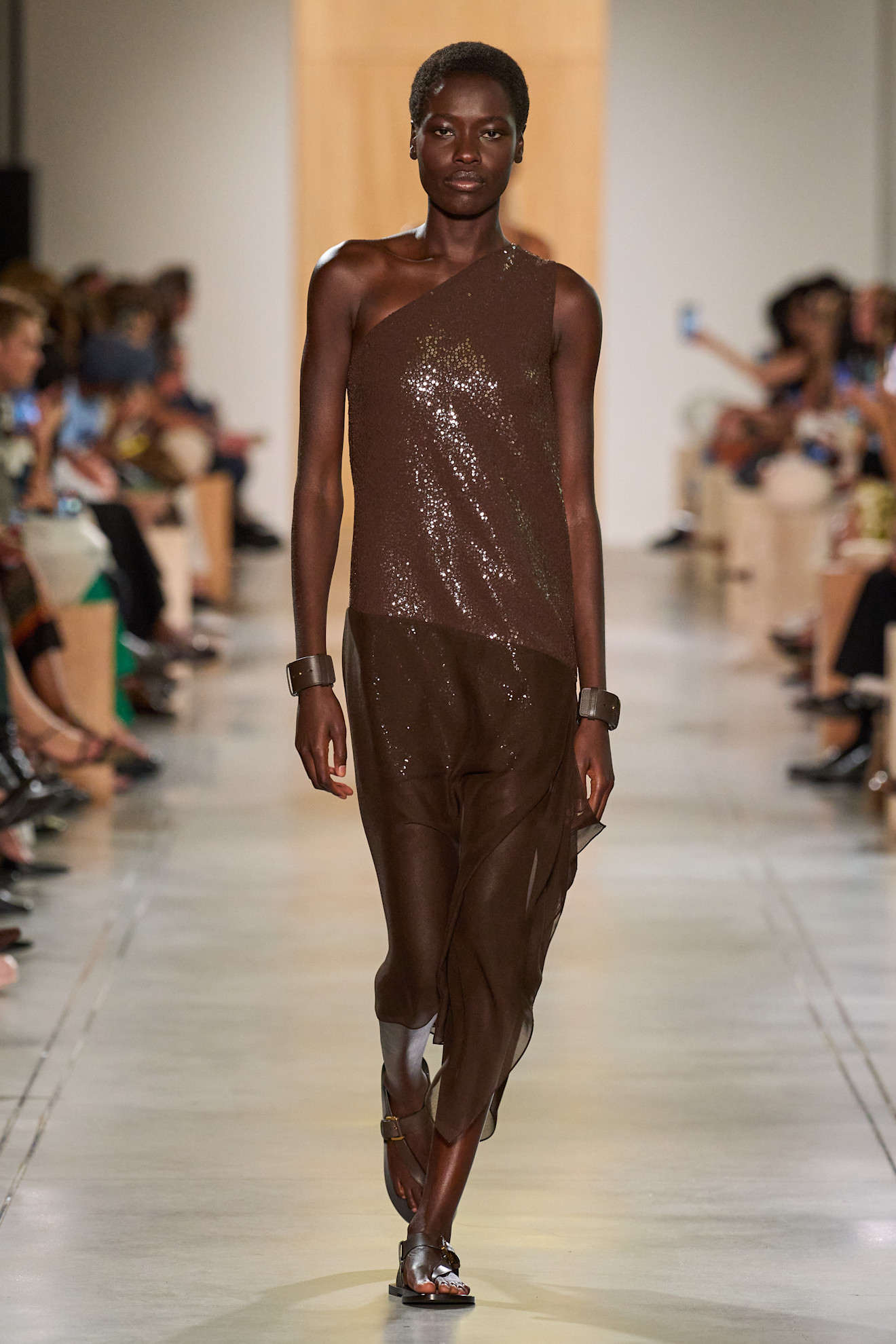 A Michael Kors model wearing a brown sequin dress