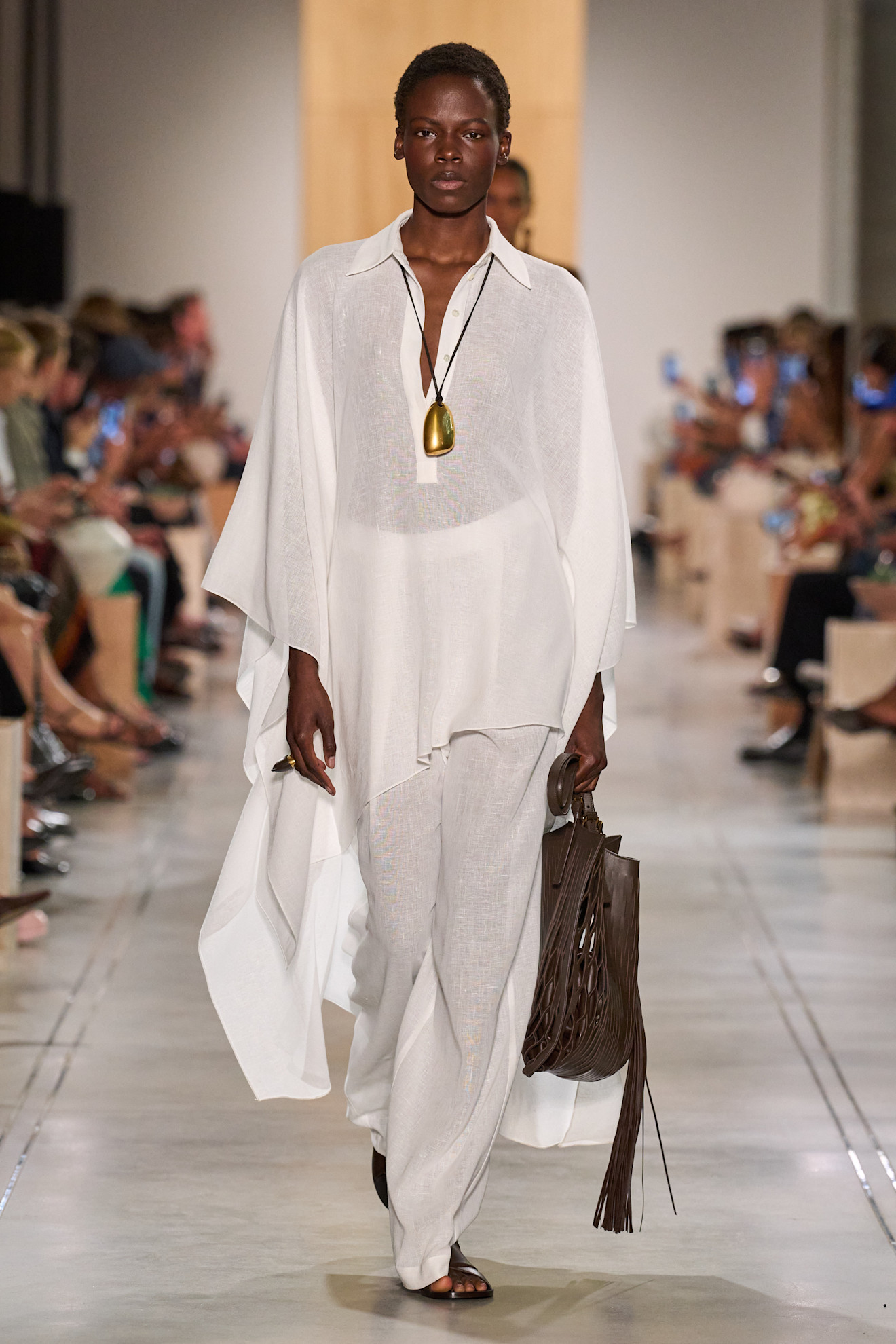 A Michael Kors model wearing all white