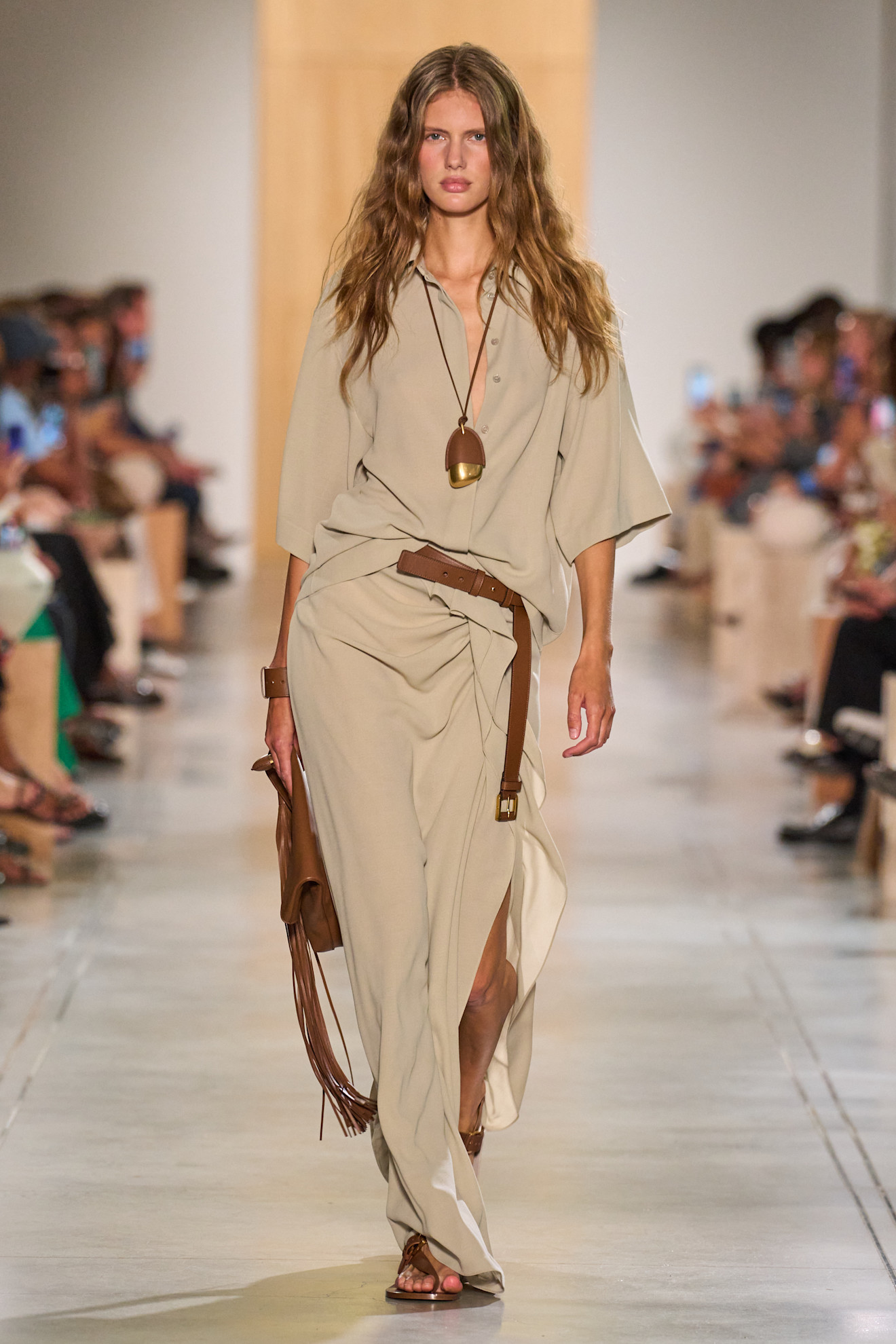 A Michael Kors model wearing a tan matching set