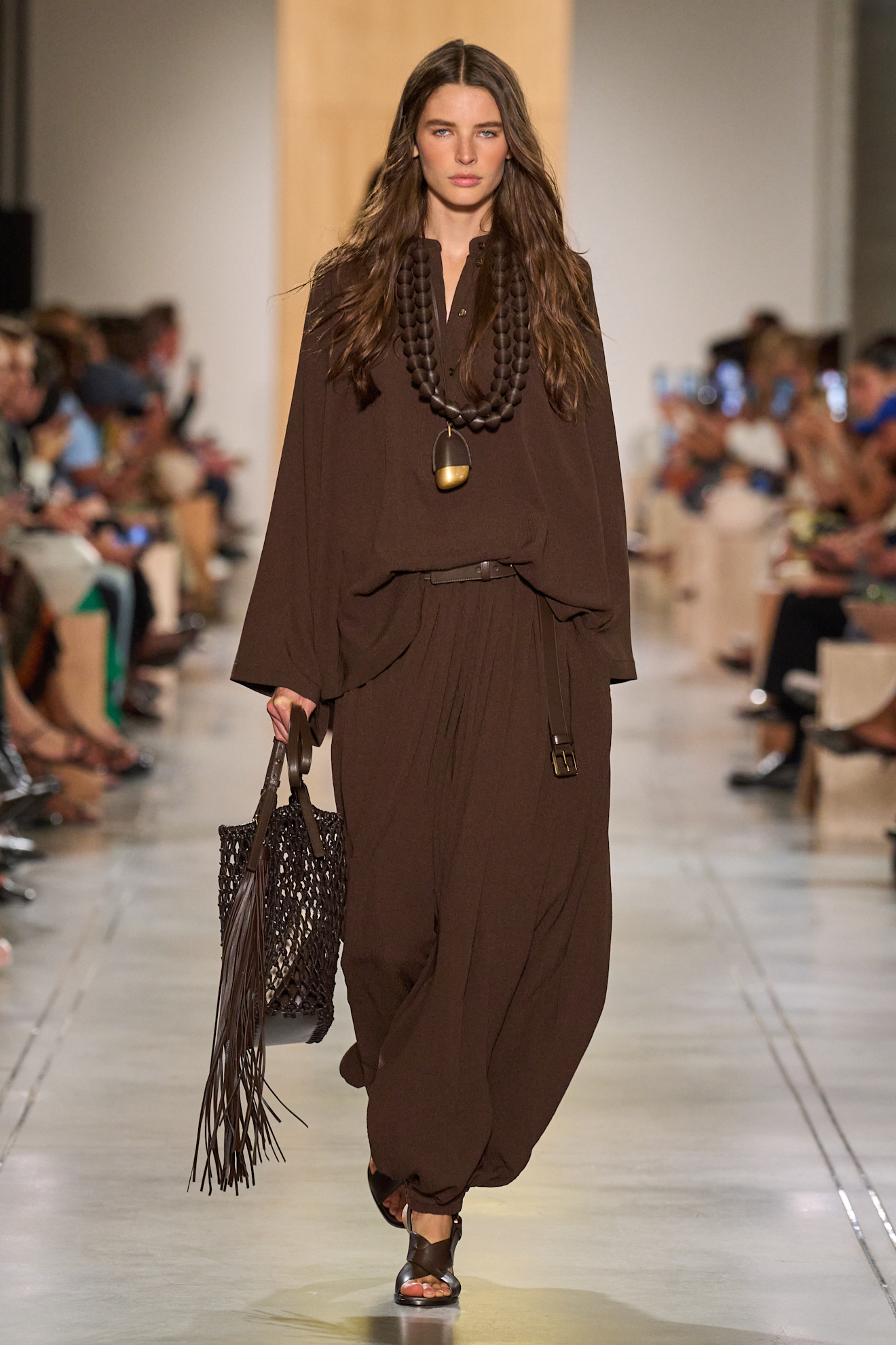 A Michael Kors model wearing a brown long sleeve set