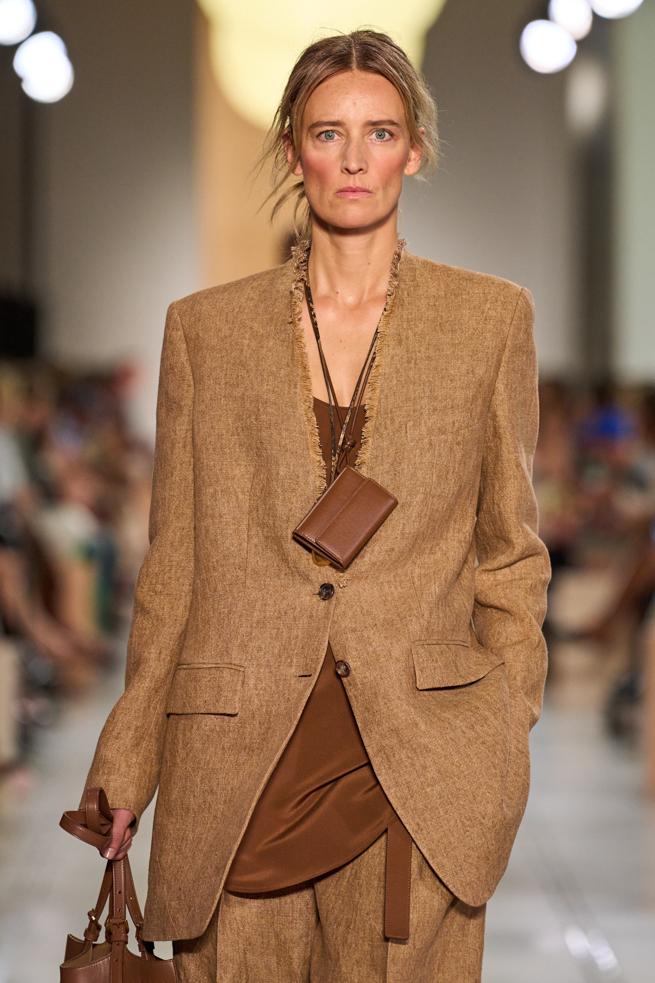 A Michael Kors model wearing a wallet necklace