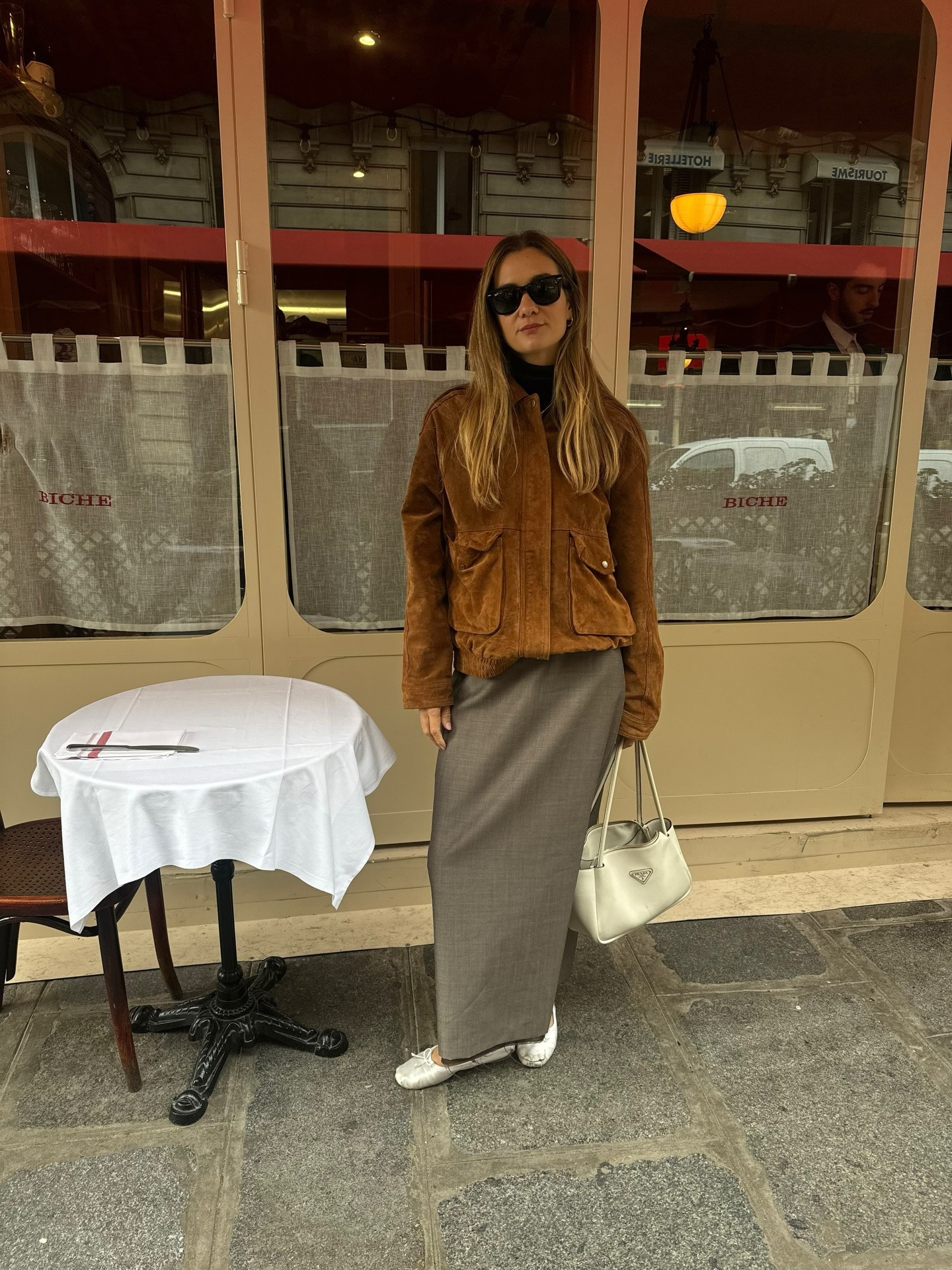 Anne Laure Mais wearing a skirt outfit idea for 2026, including a suede bomber jacket and maxi skirt.
