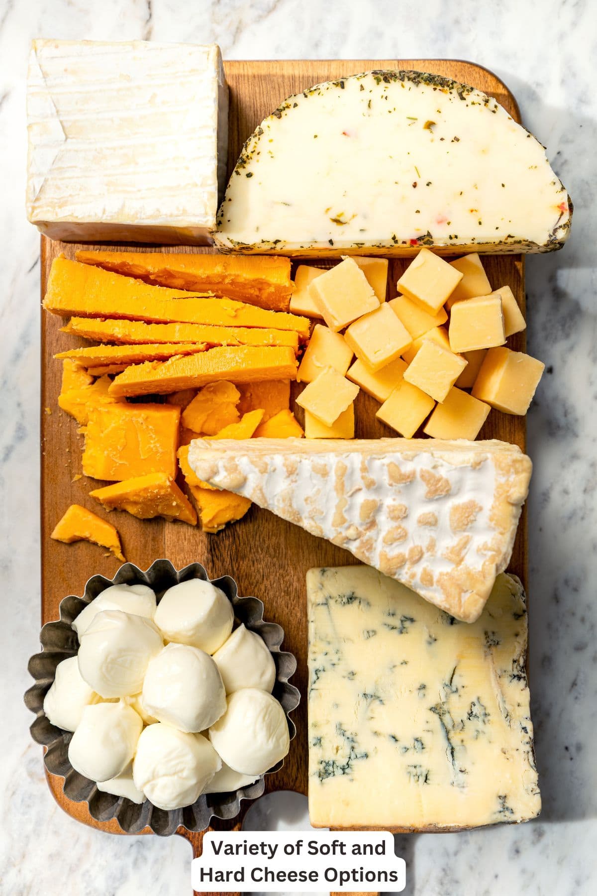 Your ultimate guide to creating a charcuterie and cheese board! I'll show you how to choose and arrange everything for a beautiful spread. Variety of cheeses for charcuterie board.