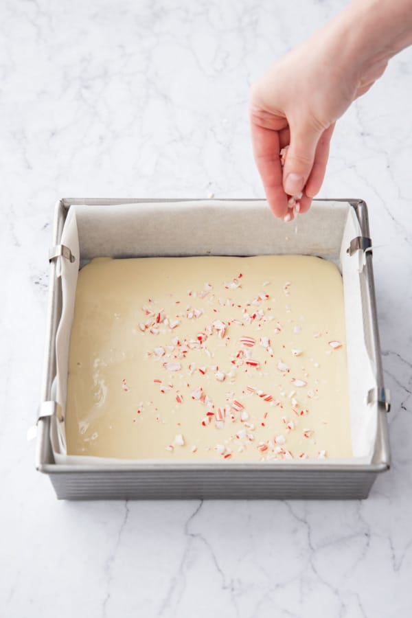 Sprinkling top of white chocolate layer with crushed up candy canes.